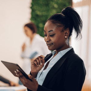 Woman at work looking confident about overcoming imposter syndrome at work.