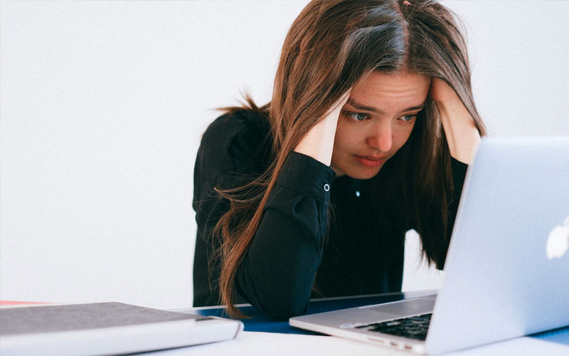 Concerned woman looking at her laptop