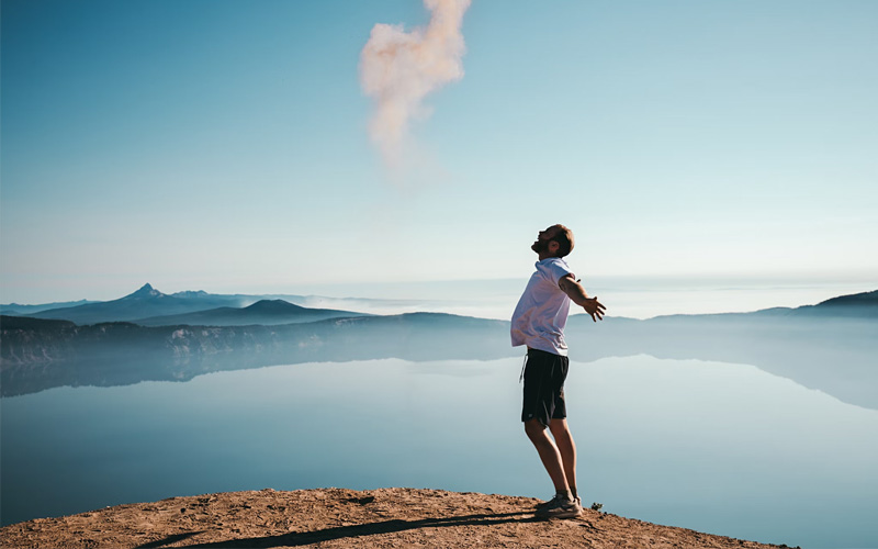 Wellness: man standing outdoors with enjoying the great outdoors